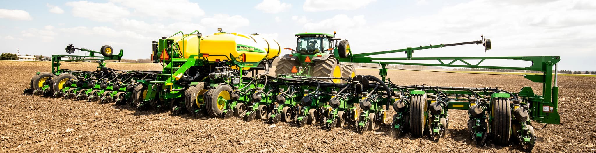 Tractor pulling a planter through a field