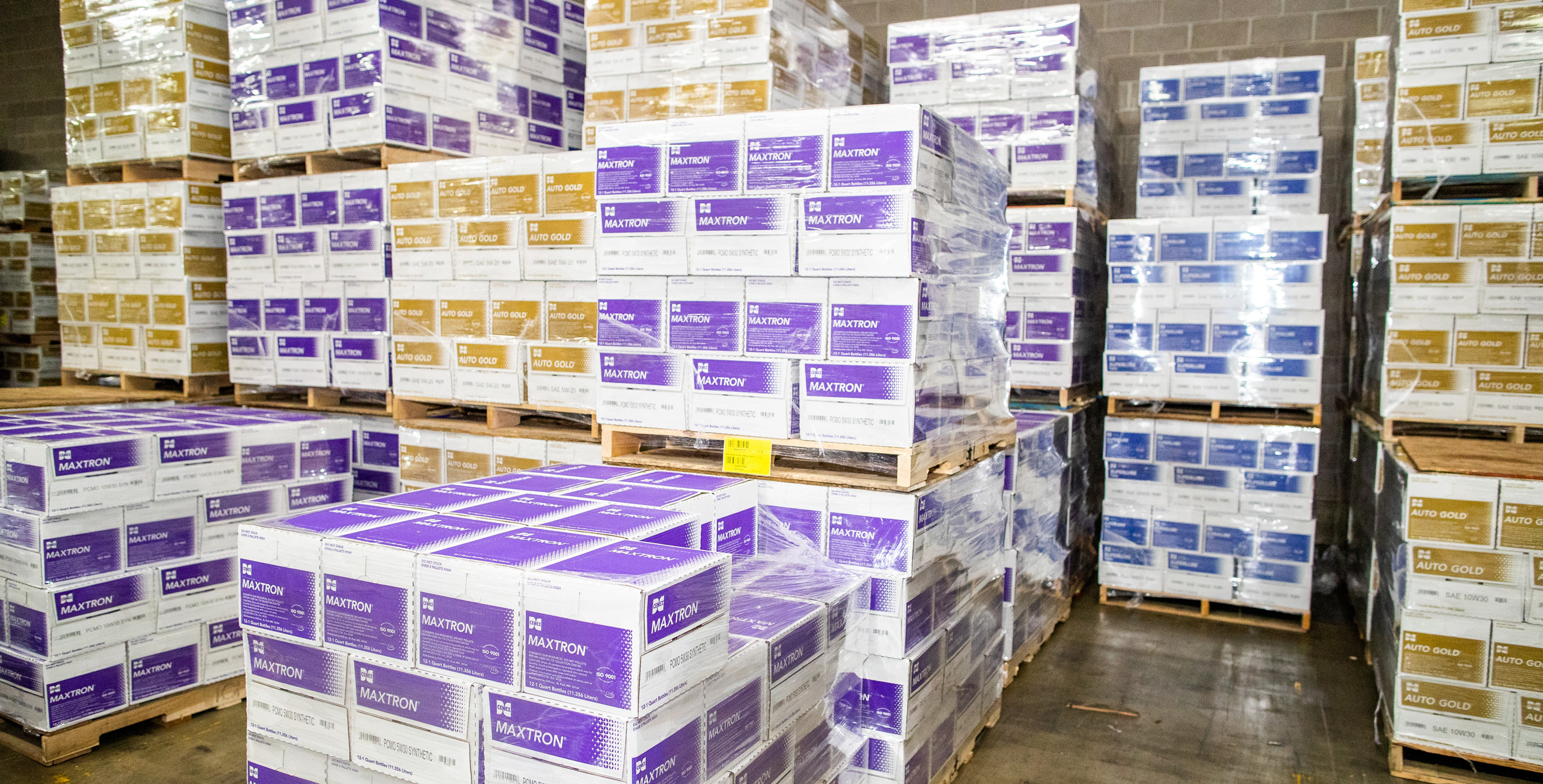 Maxtron and Auto Gold product boxes sitting on pallets